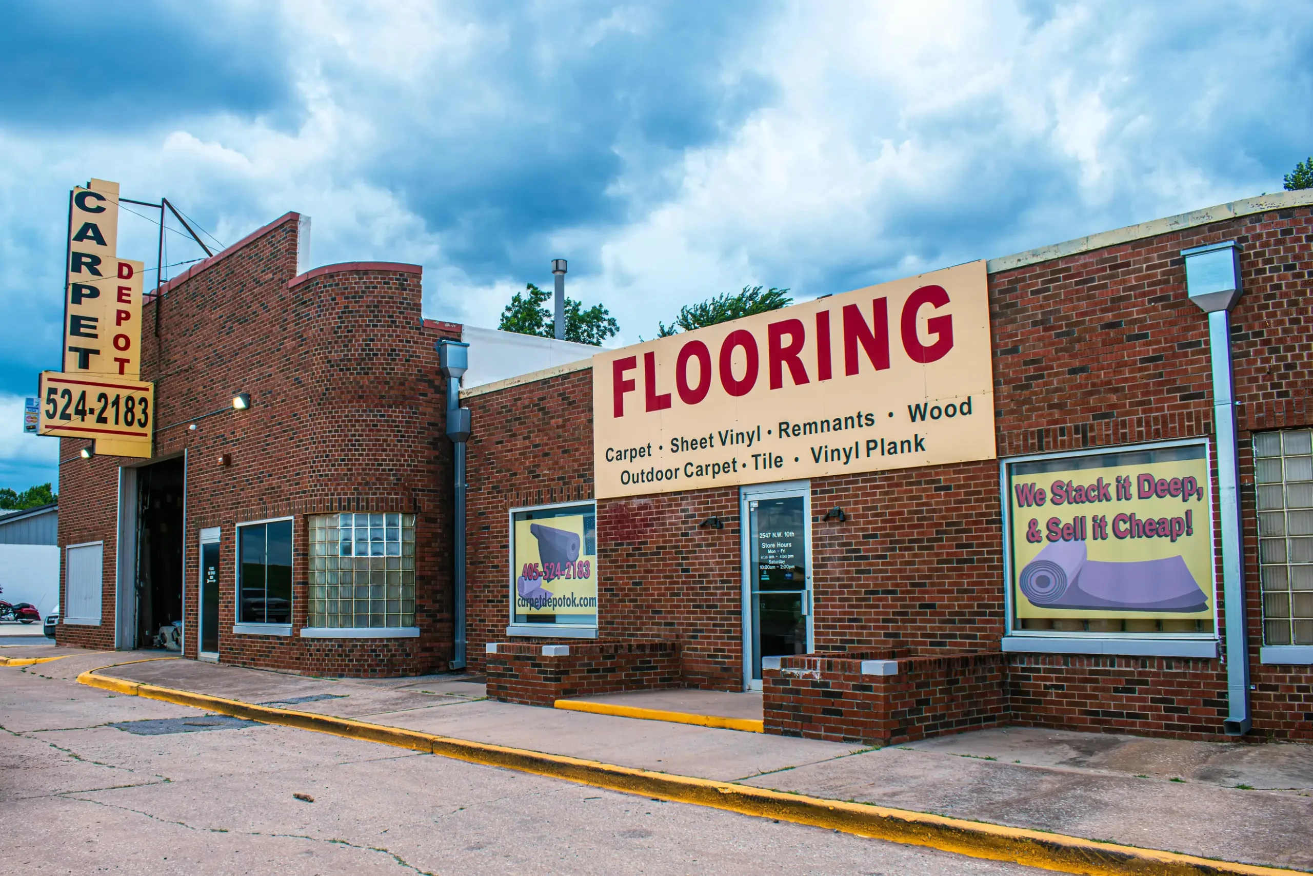 Carpet Depot brick storefront with the vertical Carpet Depot sign and the large Flooring sign visible